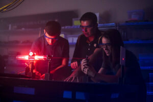 Students looking at laser